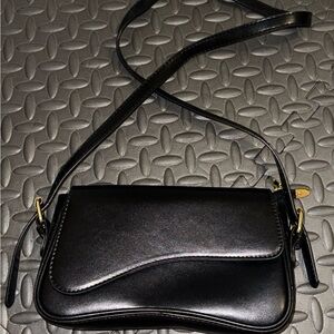 Sleek Black Crossbody Bag with Gold Accents